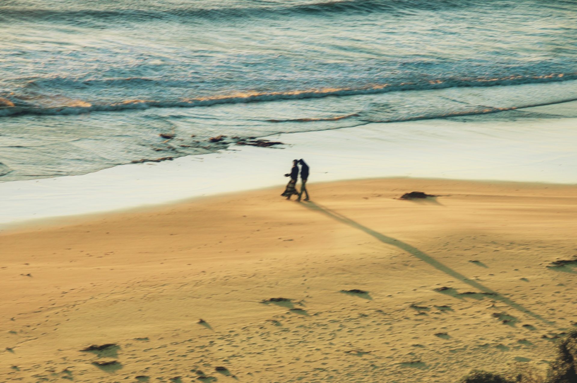 Couple walking on a sunlit beach